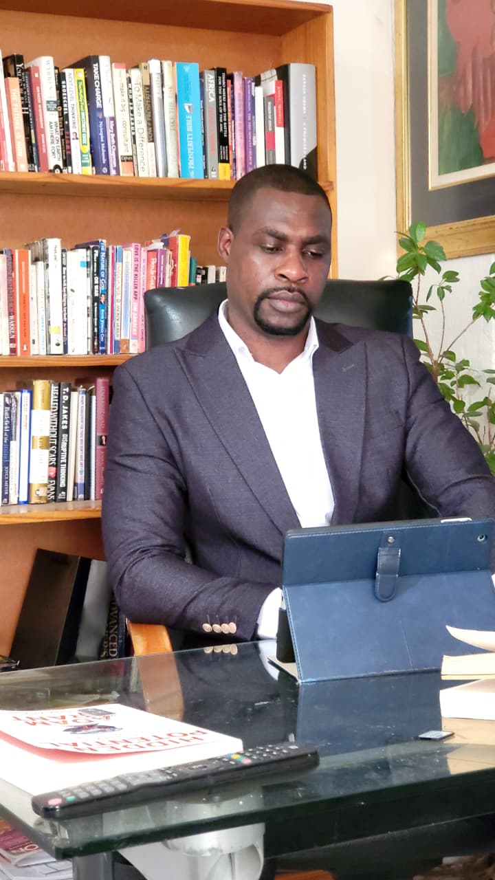 Daniel Cole writing at his desk